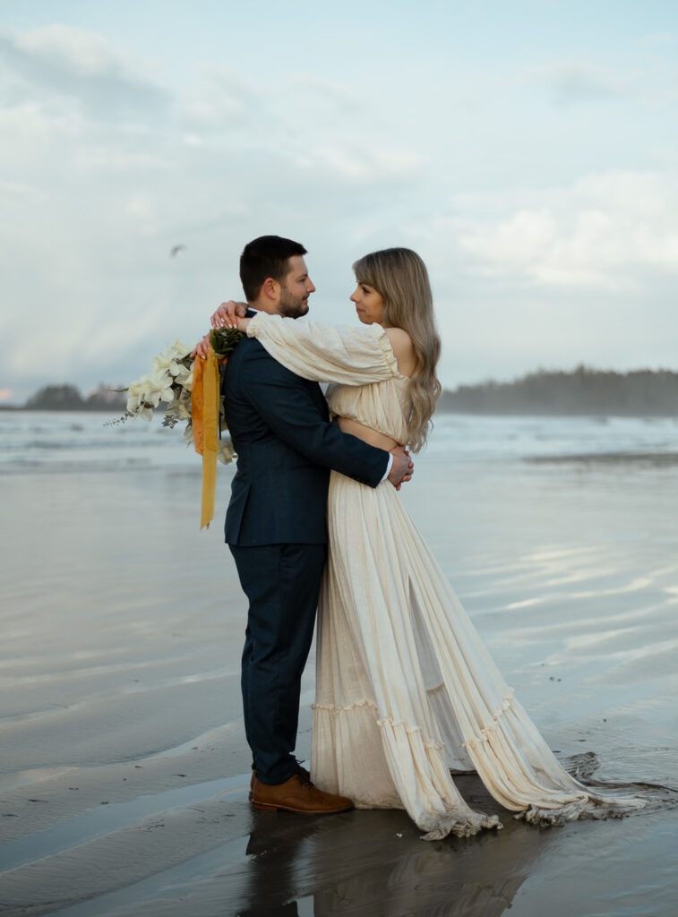 Couple having their elopement photos at a beach in Tofino British Columbia