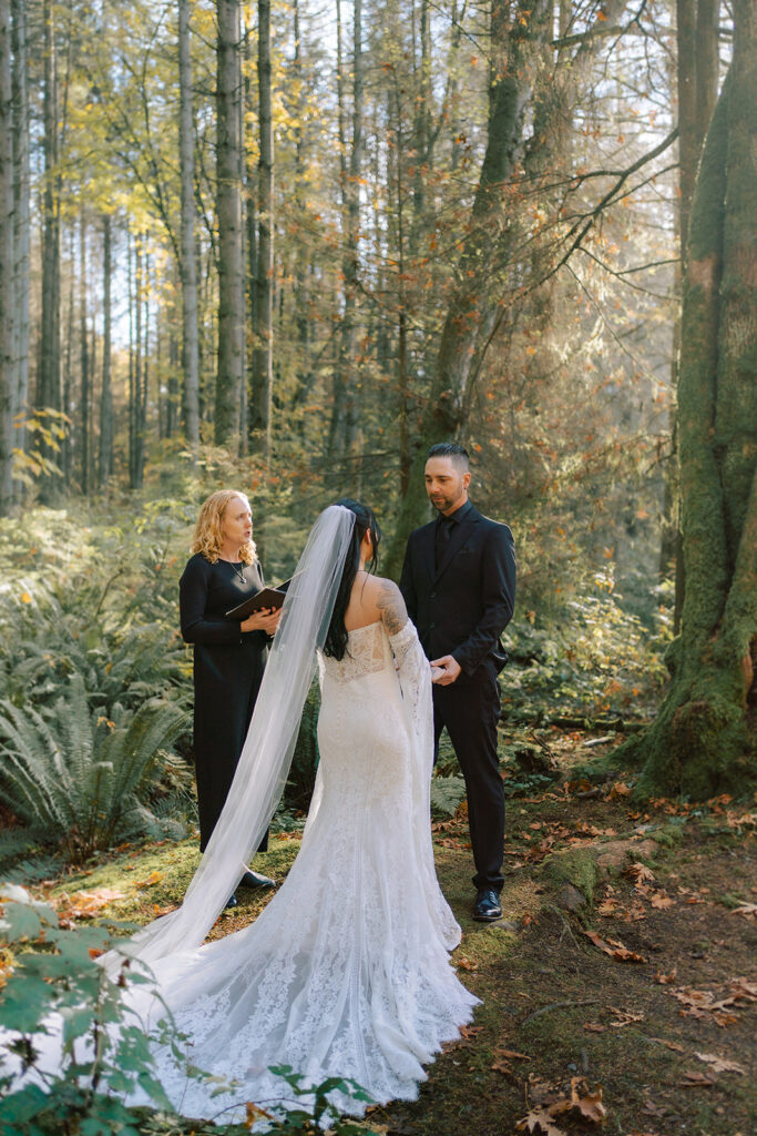 couple getting married in the forest during the fall season