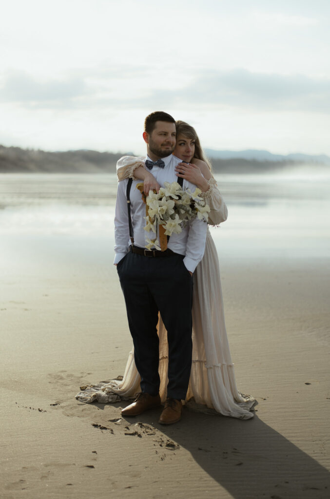 Couple having their elopement photos at a beach in Tofino British Columbia
