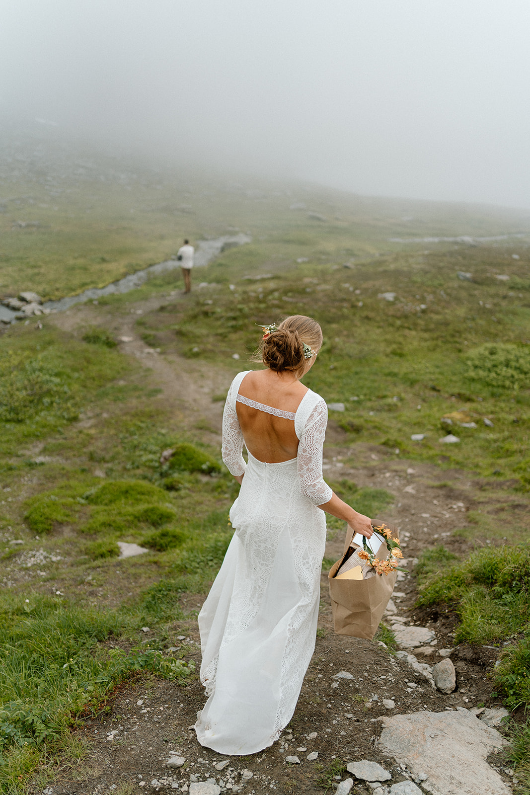 bride and groom walking in a mountain for their adventure elopement