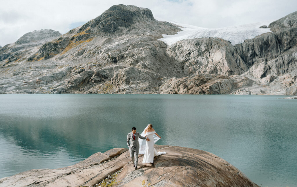 Married couple walking near an alpine lake in Whistler