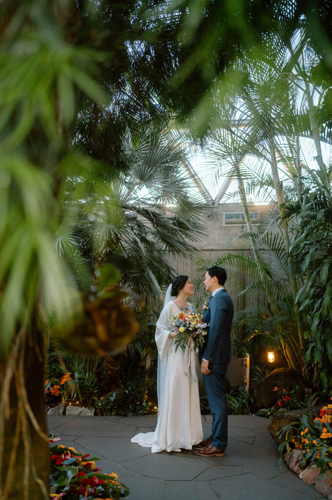married couple standing in Bloedel Conservatory Vancouver