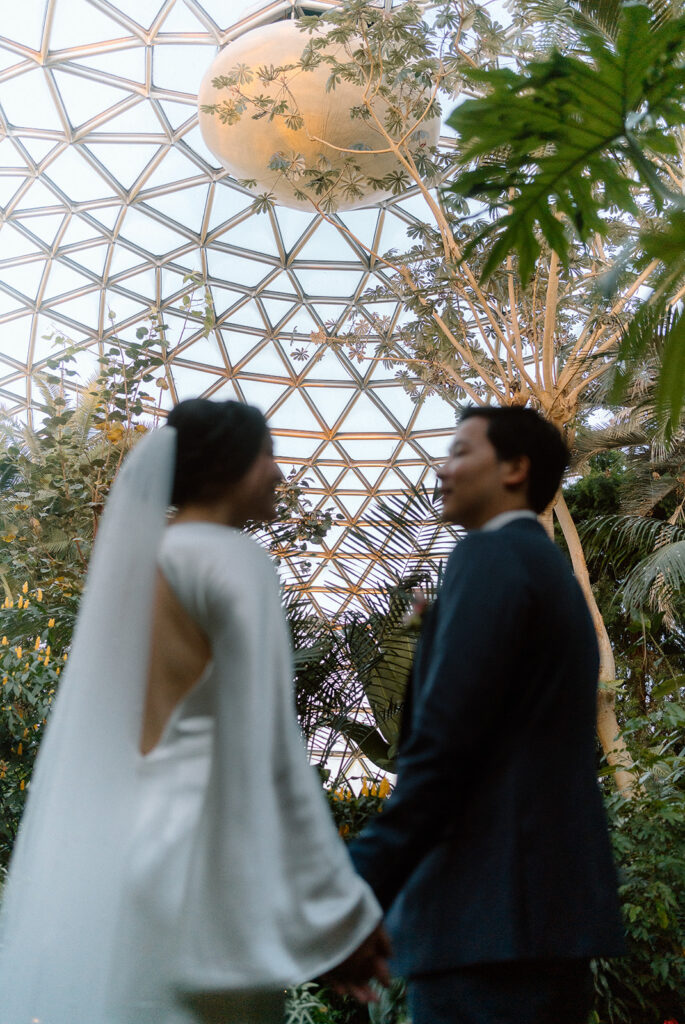 married couple standing in Bloedel Conservatory Vancouver