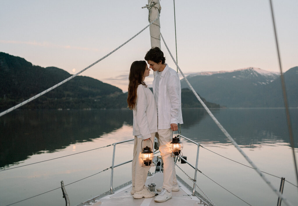 photographer captures couple on sailboat with lanterns during sunrise in Squamish BC