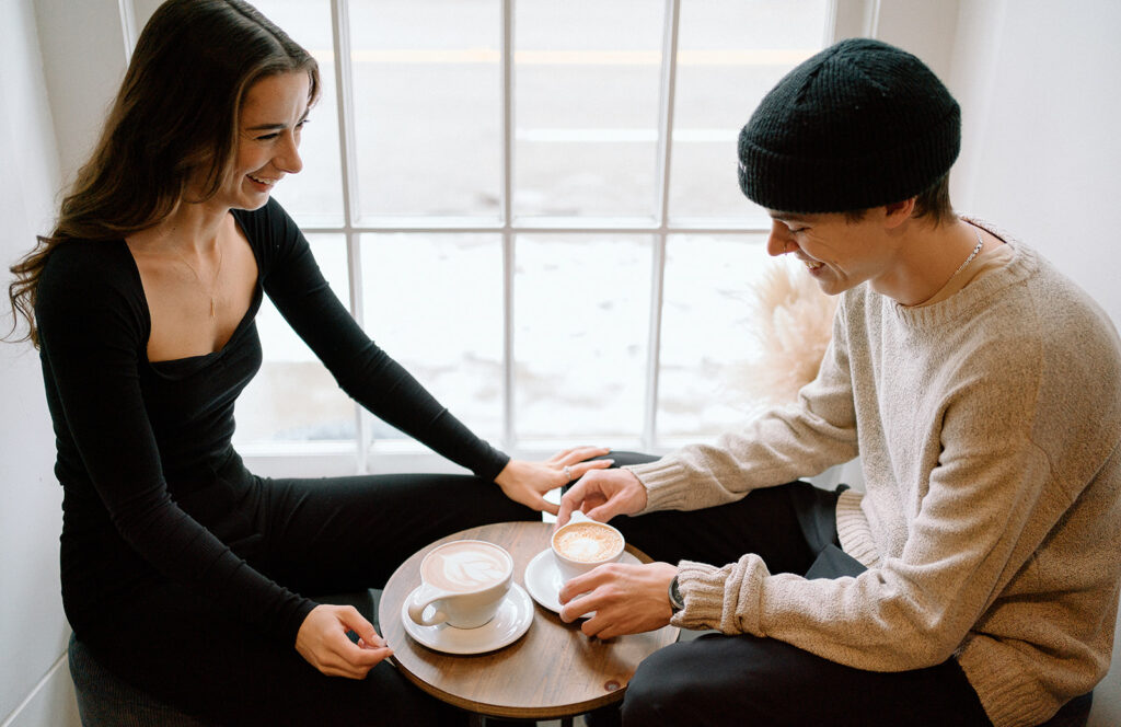 photographer captures couple drinking coffee at a coffee shop in gastown Vancouver
