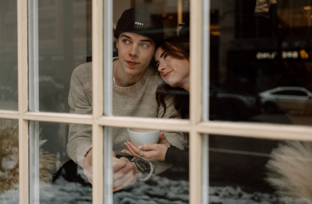 photographer captures couple drinking coffee at a coffee shop in gastown Vancouver