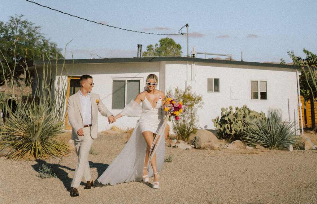 couple walking in front of cabin in the desert during their elopement