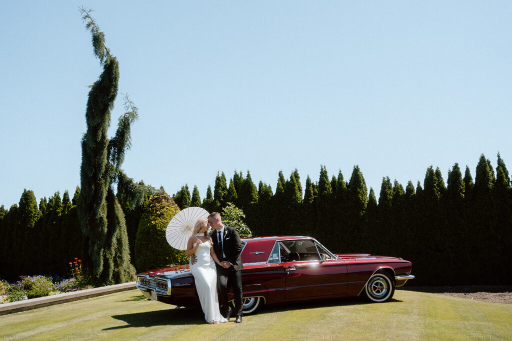 couple leaning against vintage car during Italian wedding